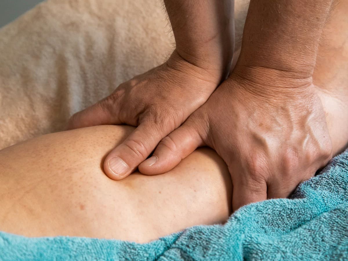 Patient lying supine for calm breathing and rib mobility work after medical clearance