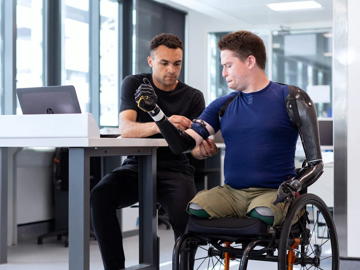 Person seated at a desk — typical posture and ergonomics reviewed in clinic